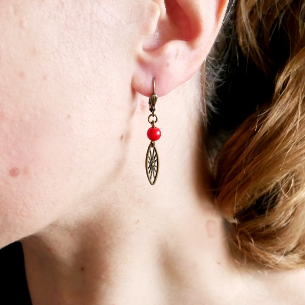 Aged bronze pendant earrings with a red glass bead Earrings 17,00 €
