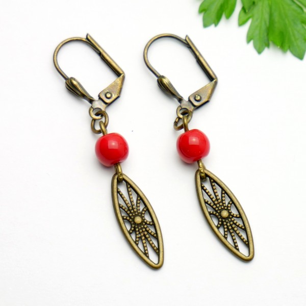 Aged bronze pendant earrings with a red glass bead Earrings 17,00 €