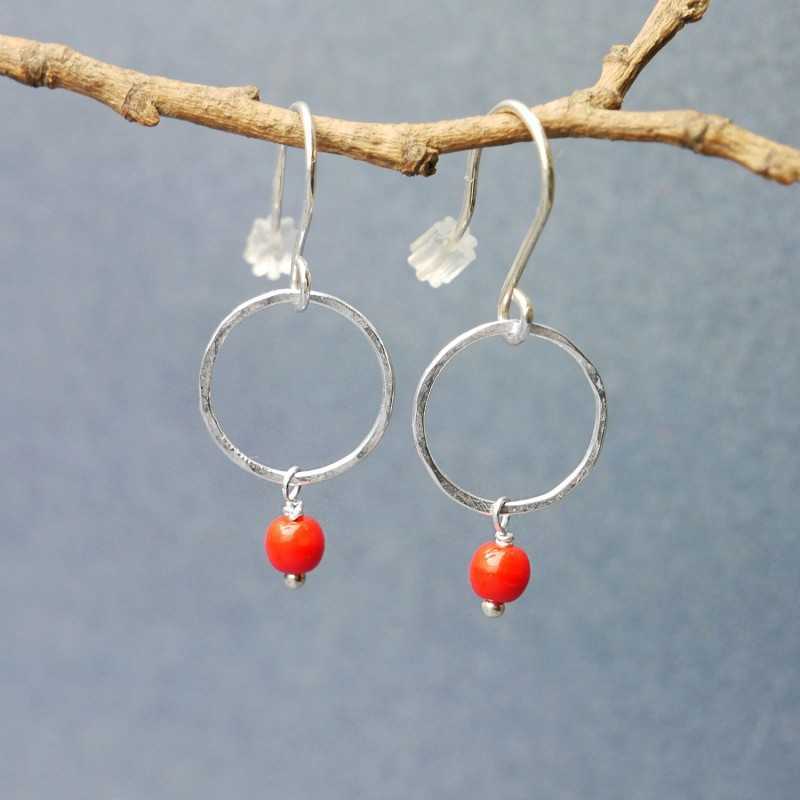 Minimalist round dangling earrings with a small red glass bead in u...